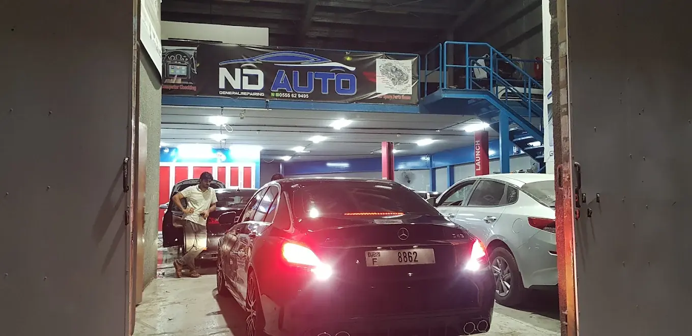 ND Auto General Repair workshop at night - Mercedes entering
