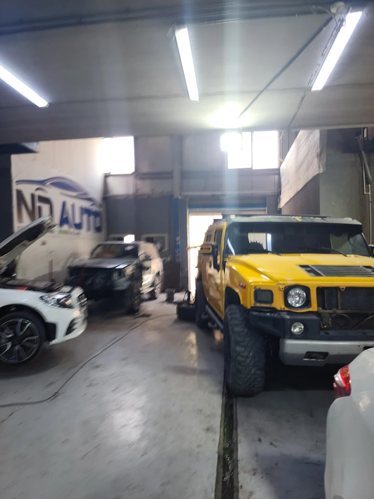 Yellow Hummer H2 and VW in workshop